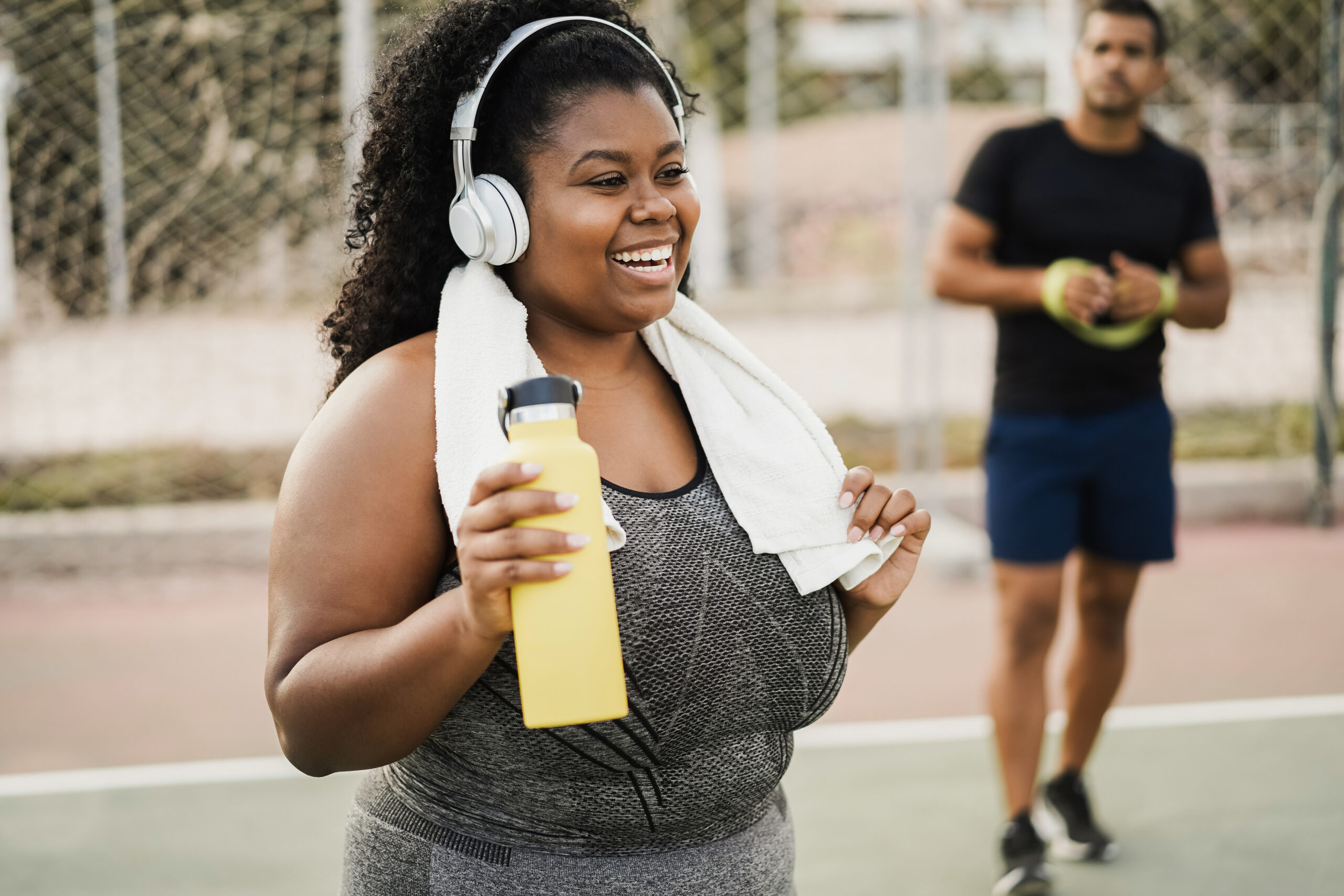 Curvy woman doing workout morning routine outdoor at city park - Focus on face - Maryland Weight Care do weight loss medications make you lose muscle