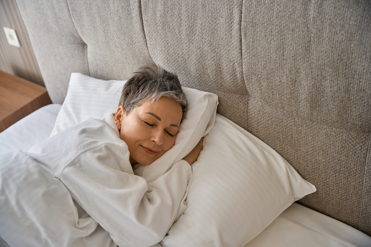 Adult lady in bathrobe resting in hotel room while sleeping - Maryland Weight Care
