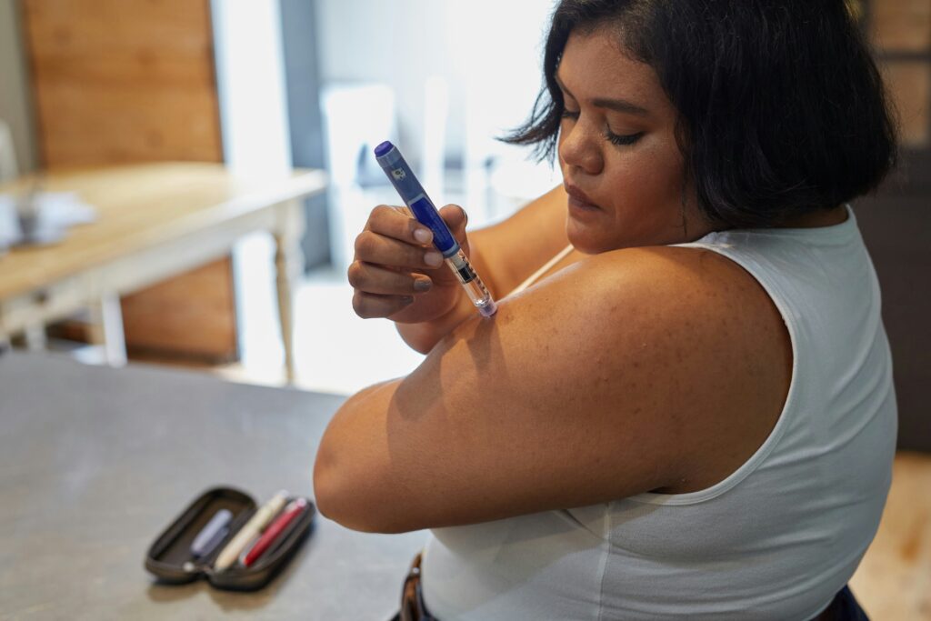 sweet-life-o1N2-pSIhbw-unsplash - Maryland Weight Care Woman receiving a vaccination in her upper arm using a syringe, close-up of the injector and her bare shoulder.